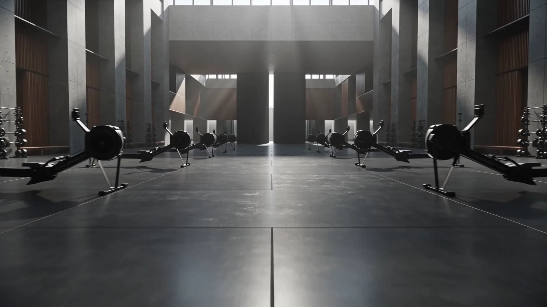 A line of early morning light moving through a dark architectural gym in Doha, matte black equipment emerging from shadow.